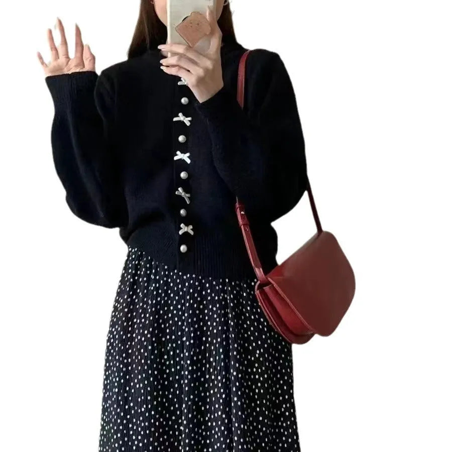 Women's solid colour cardigan sweater with a front bow decoration and pearl buttons.