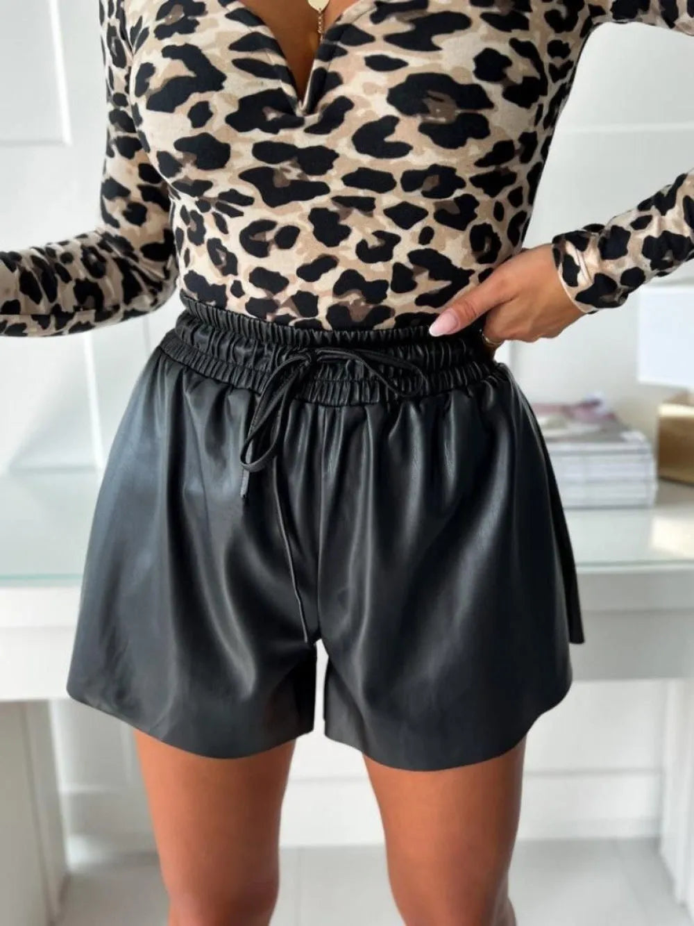 Women's black wide-leg shorts with lace-up drawstring waist detail and straight-leg silhouette