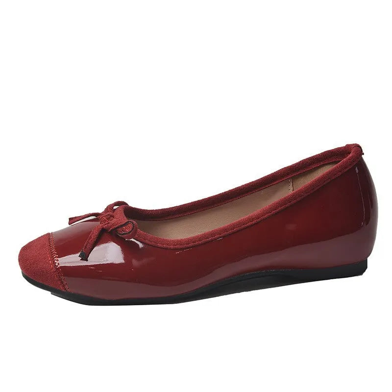 Retro apricot colour Mary Jane ballet flats with bow detail and square toe on a white background.