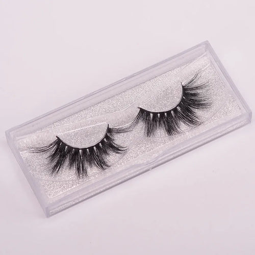 Handmade 5D mink false eyelashes set with storage case and double-headed brush on a clean background.