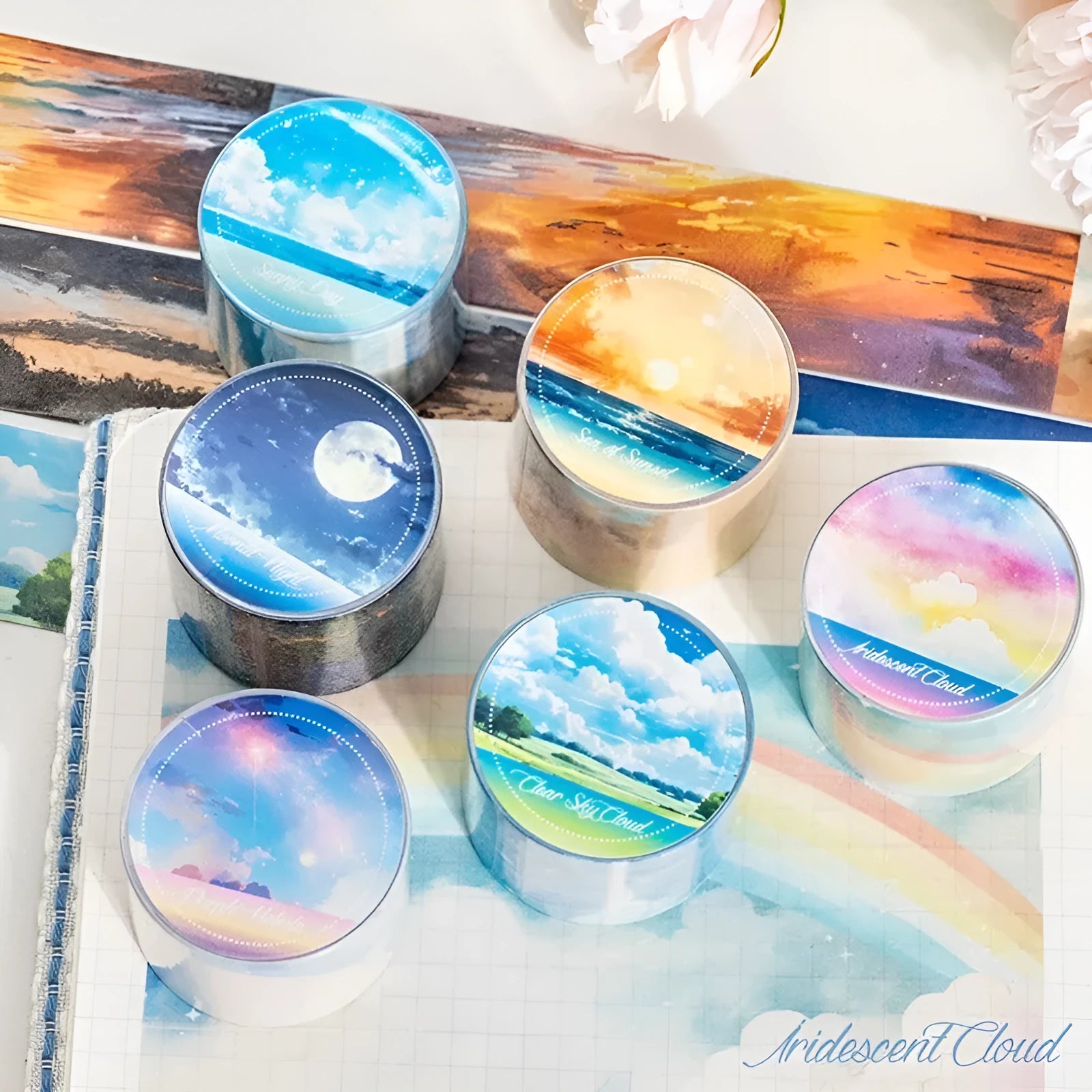 Roll of Japanese paper decorative tape with sky theme patterns including clouds, sun, moon, and nebula.