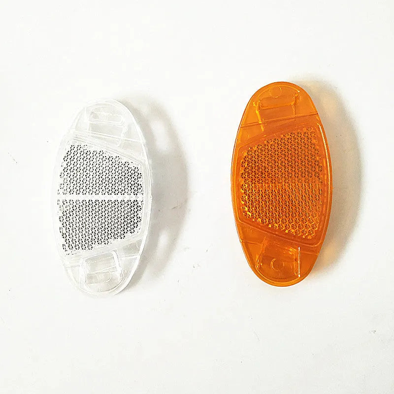 White and yellow plastic bicycle spoke reflectors with reflective warning film