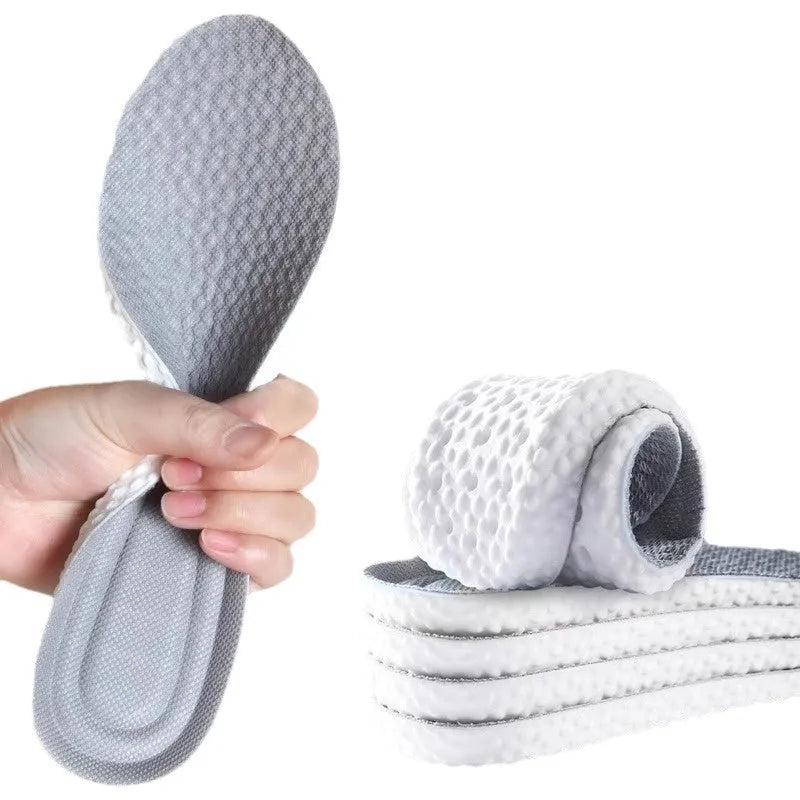 A pair of grey high-elasticity PU foam sports insoles on a white background, shown with scissors to illustrate the cut-to-fit design.