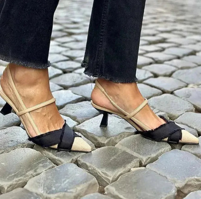 Women's apricot and black colour block pointed toe stiletto sandals with a buckle strap.