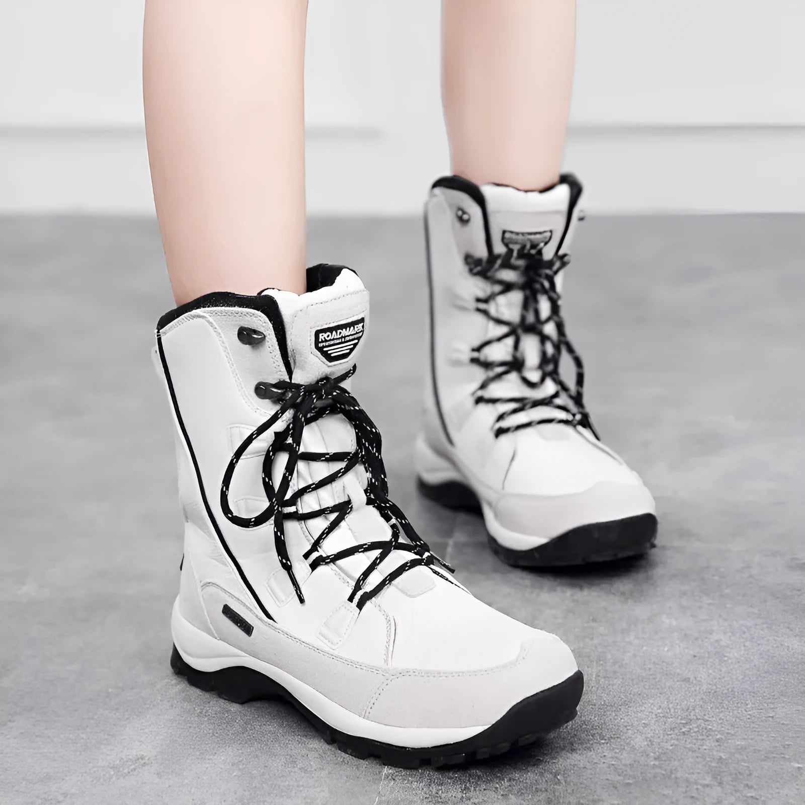 Women's mid-calf thermal snow boot in black with a round toe, genuine leather upper, and rubber sole.