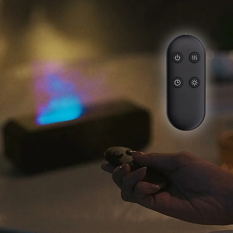 Black USB aroma diffuser with colour-changing LED lights and remote control on a wooden table.