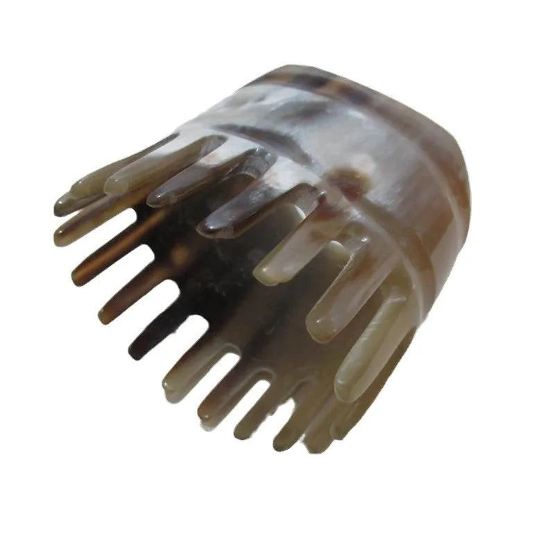 Black buffalo horn comb with wide teeth and pointed tips for scalp massage