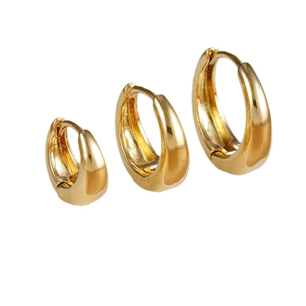 Three glossy geometric copper earrings set in gold electroplated finish