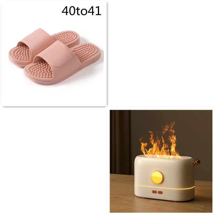 Black USB humidifier with flickering flame effect and water tank on wooden desktop