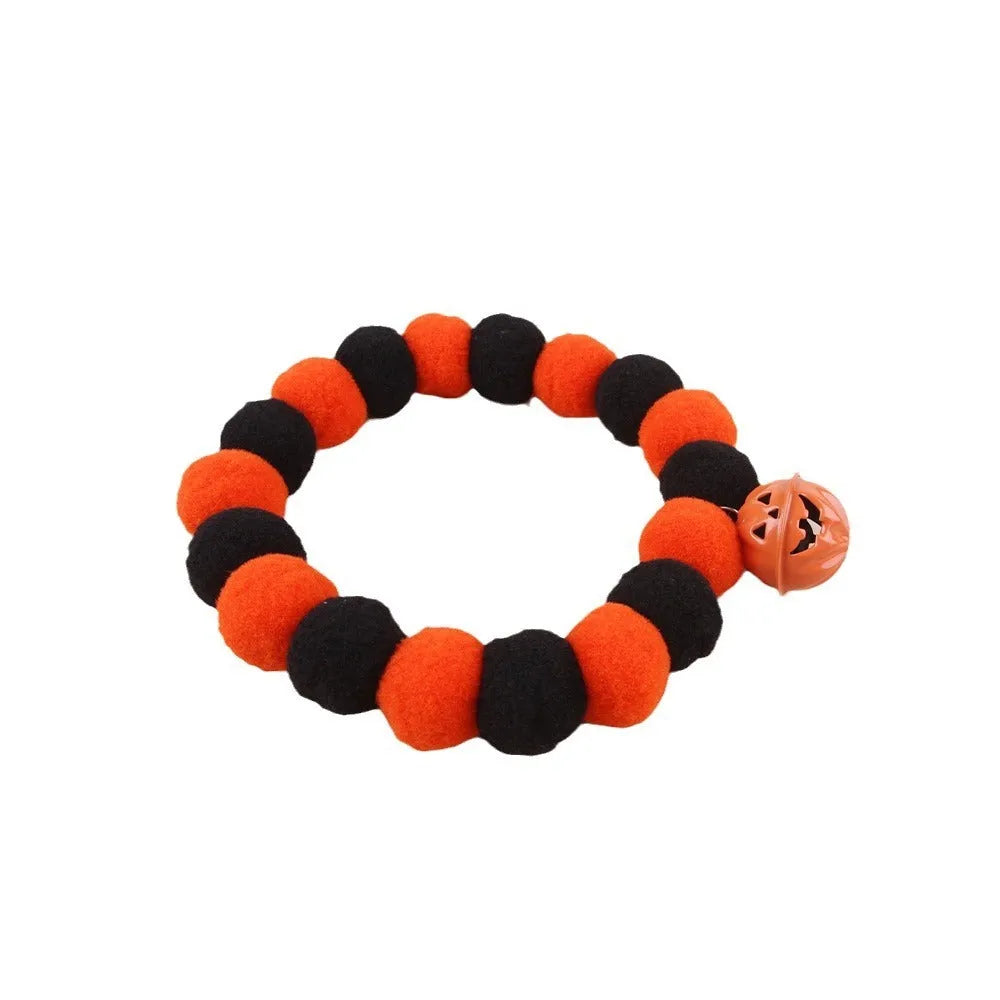 Halloween pumpkin-themed cat collar with Trick or Treat text and adjustable buckle.