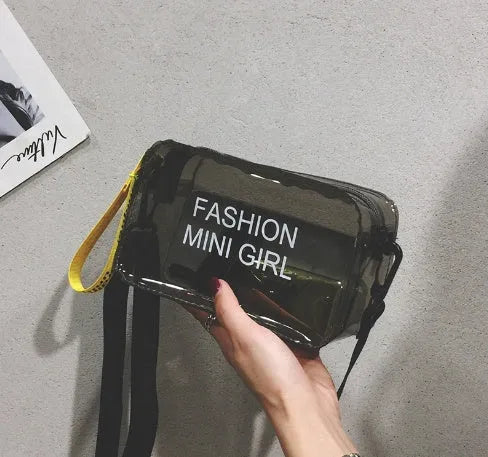 A transparent square jelly crossbody bag with a single adjustable shoulder strap.