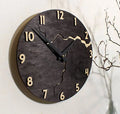 Modern round wooden wall clock with crackle design, white face, and black hands.