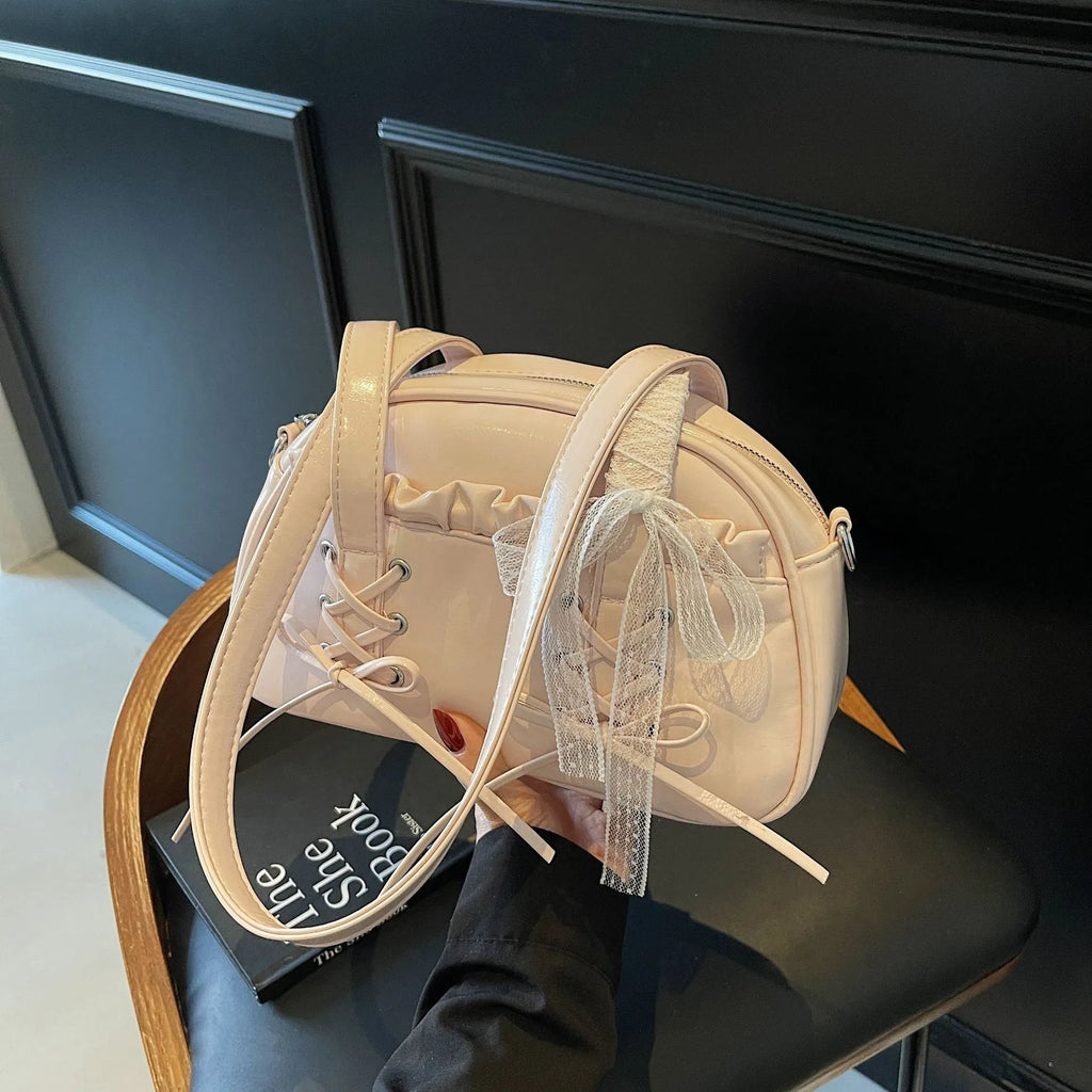 Women's casual PU leather handbag with a bandage bow decoration on the front.