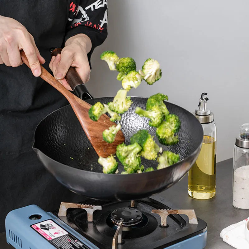 Traditional black iron wok with wooden handle measuring 32cm cooking surface diameter