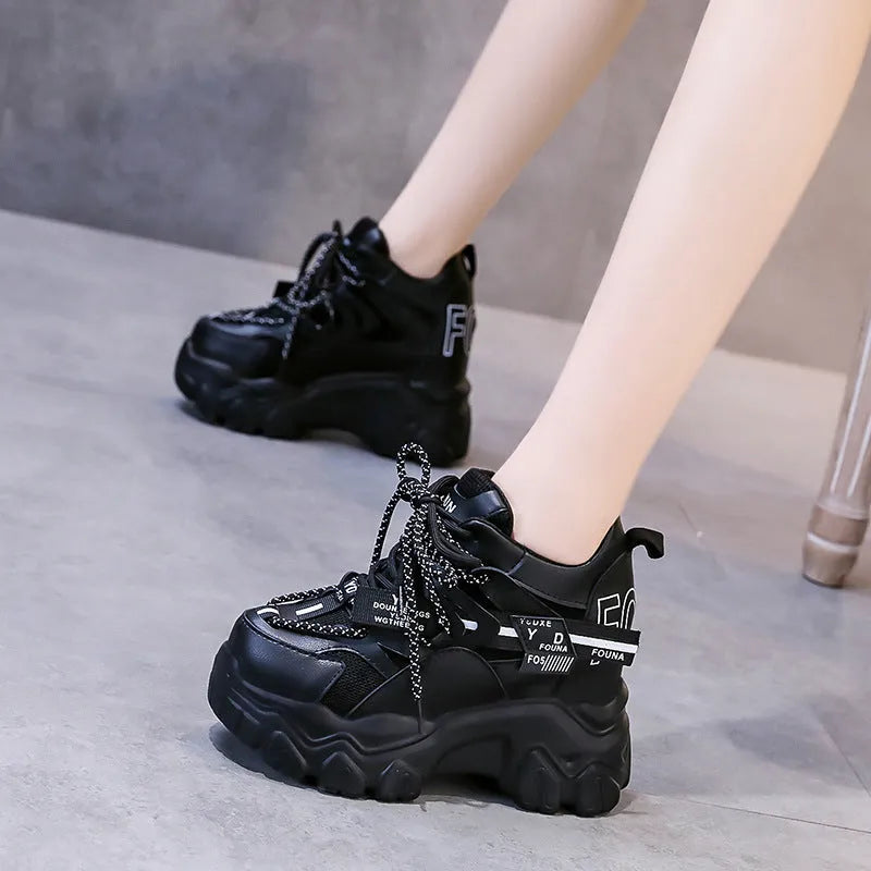 Women's white breathable mesh platform sports shoe with a cross strap on a rubber sole