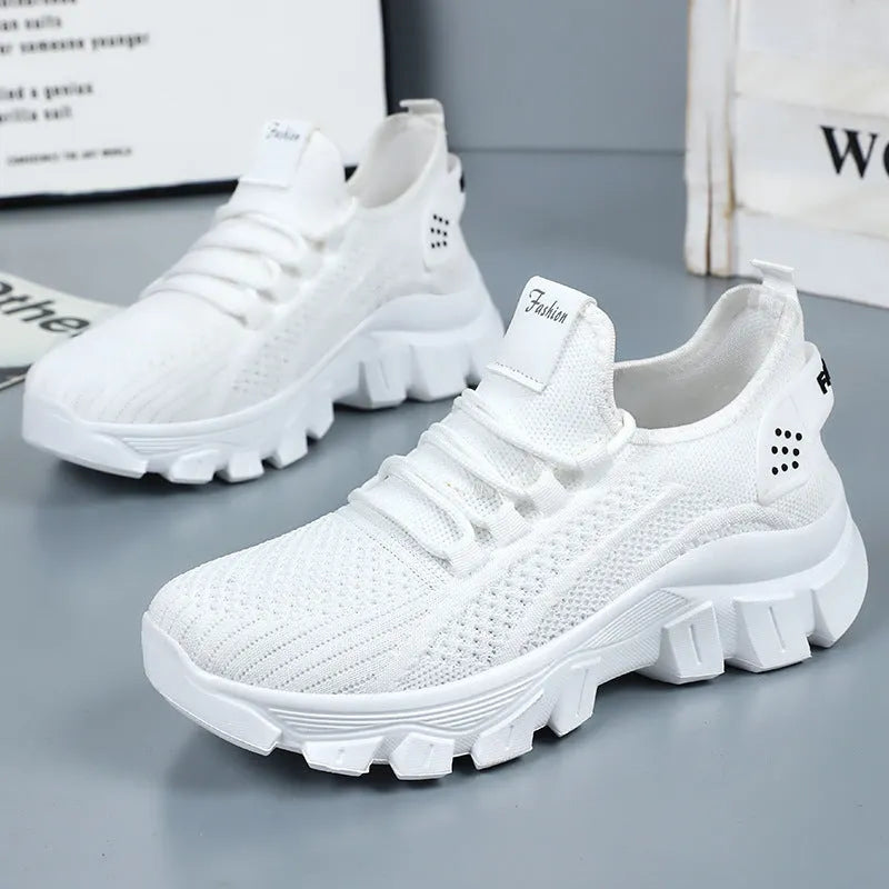Women's white Flyknit sneaker with thick PVC sole and front lace-up design