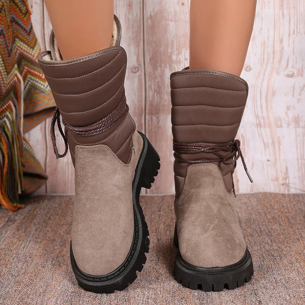 Women's black suede chunky heel snow boots with lace-up design and high top.