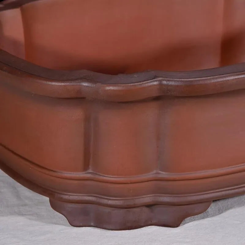 Large antique-style purple clay Chinese flower pot showing wide, shallow shape.