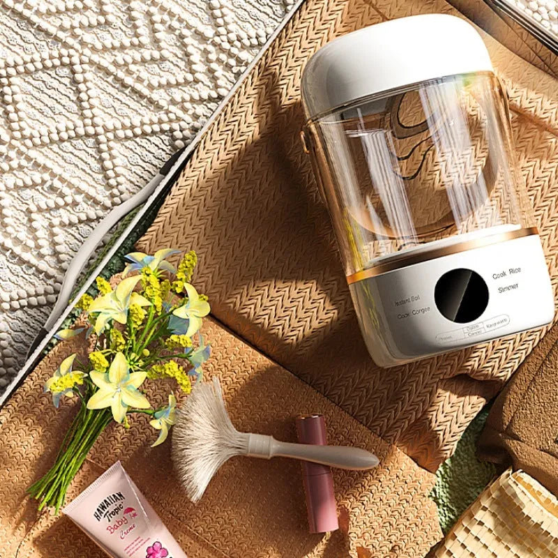 Smart portable electric stew cooker with transparent glass lid showing food inside, on a kitchen counter.