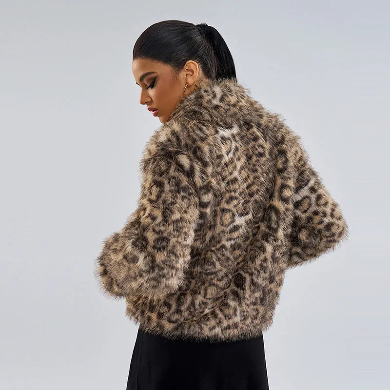 Women's leopard print coat with buckle lapel closure showing regular sleeves and normal length