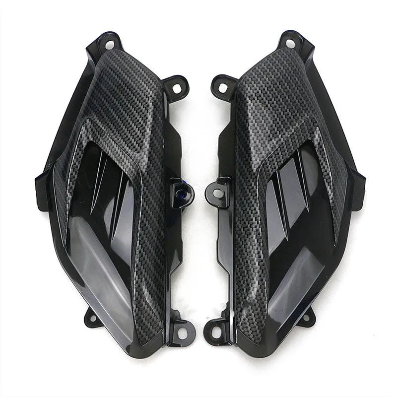 Pair of Yamaha NMAX LED side lamps with carbon fibre design on a blue background.