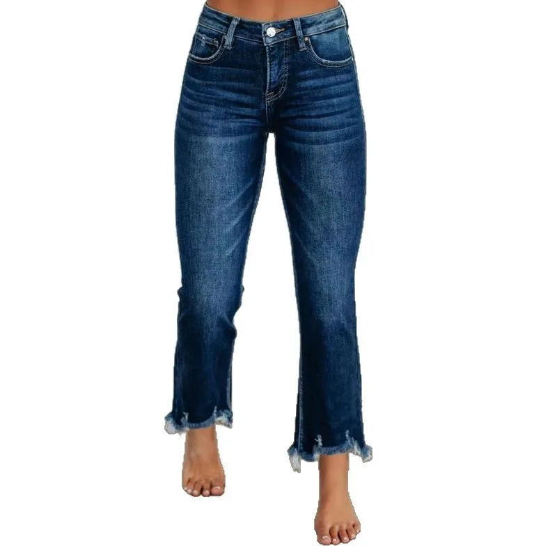 Women's solid colour denim jeans with hand-worn distressing in dark blue on a model