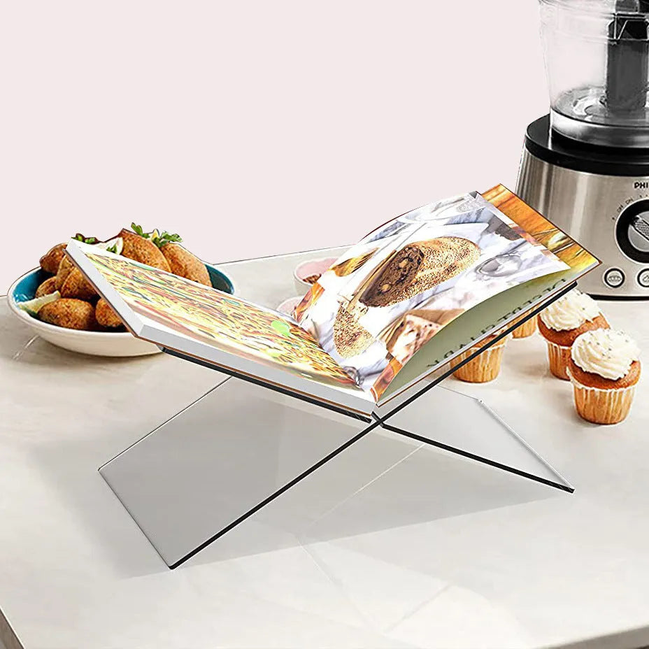 Transparent X-shaped acrylic book reading rack displaying books on desktop