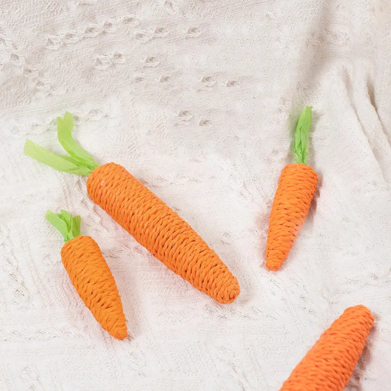 Assortment of interactive cat toys including carrot bites, paper toys, ringing stones, and dental sticks in two sizes