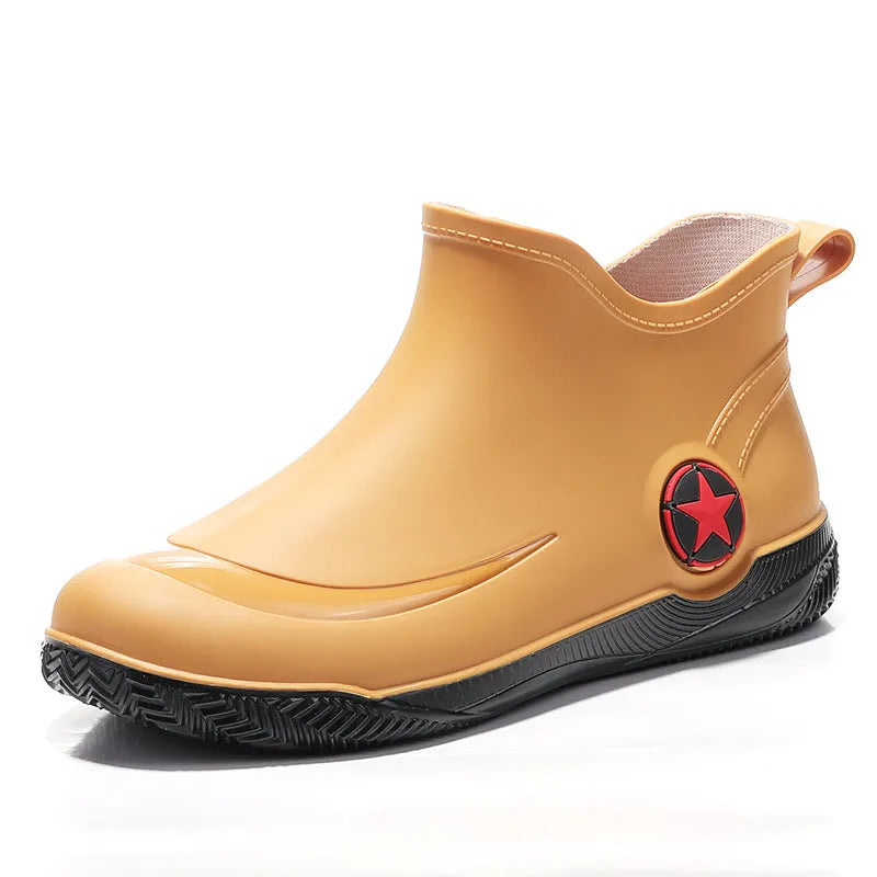 Unisex low-cut PVC rain boots in black with round toe and moulded plastic sole