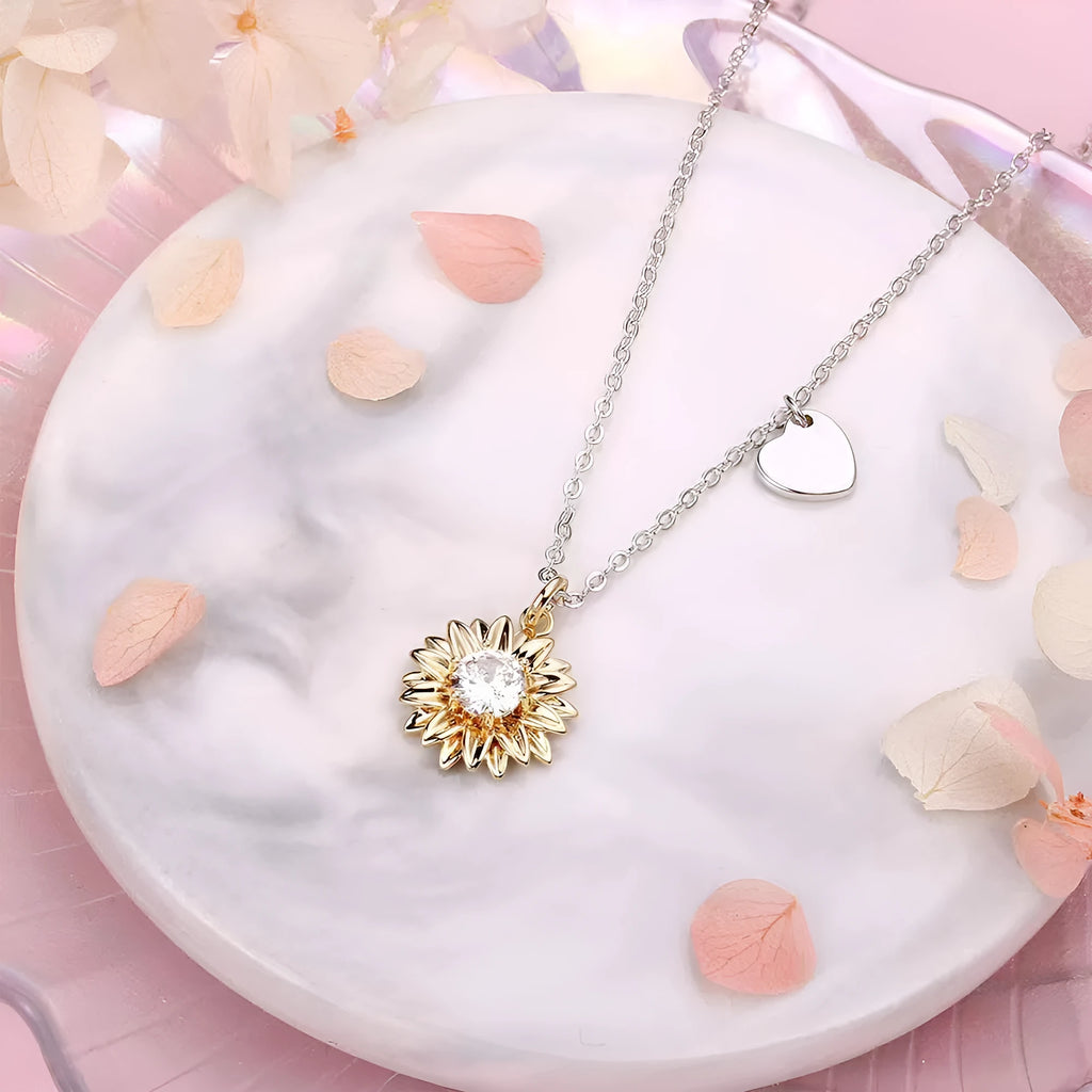 Sterling silver sunflower pendant necklace with adjustable chain on grey background