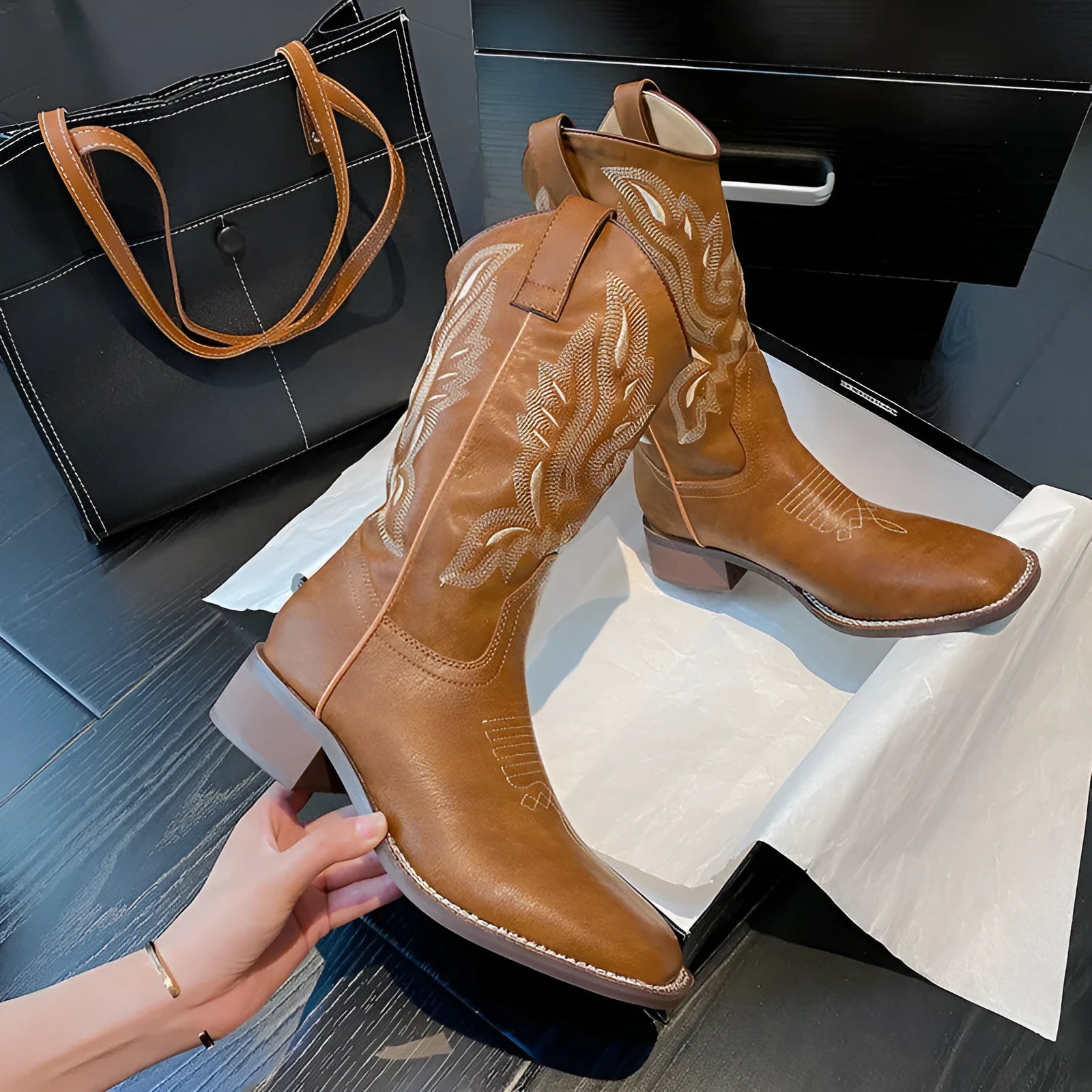 Brown women's embroidered Martin boots with a mid-calf height and low square heel.