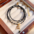 Women's three-ring bracelet with blue sand stone beads in multi-layered gold-tone design
