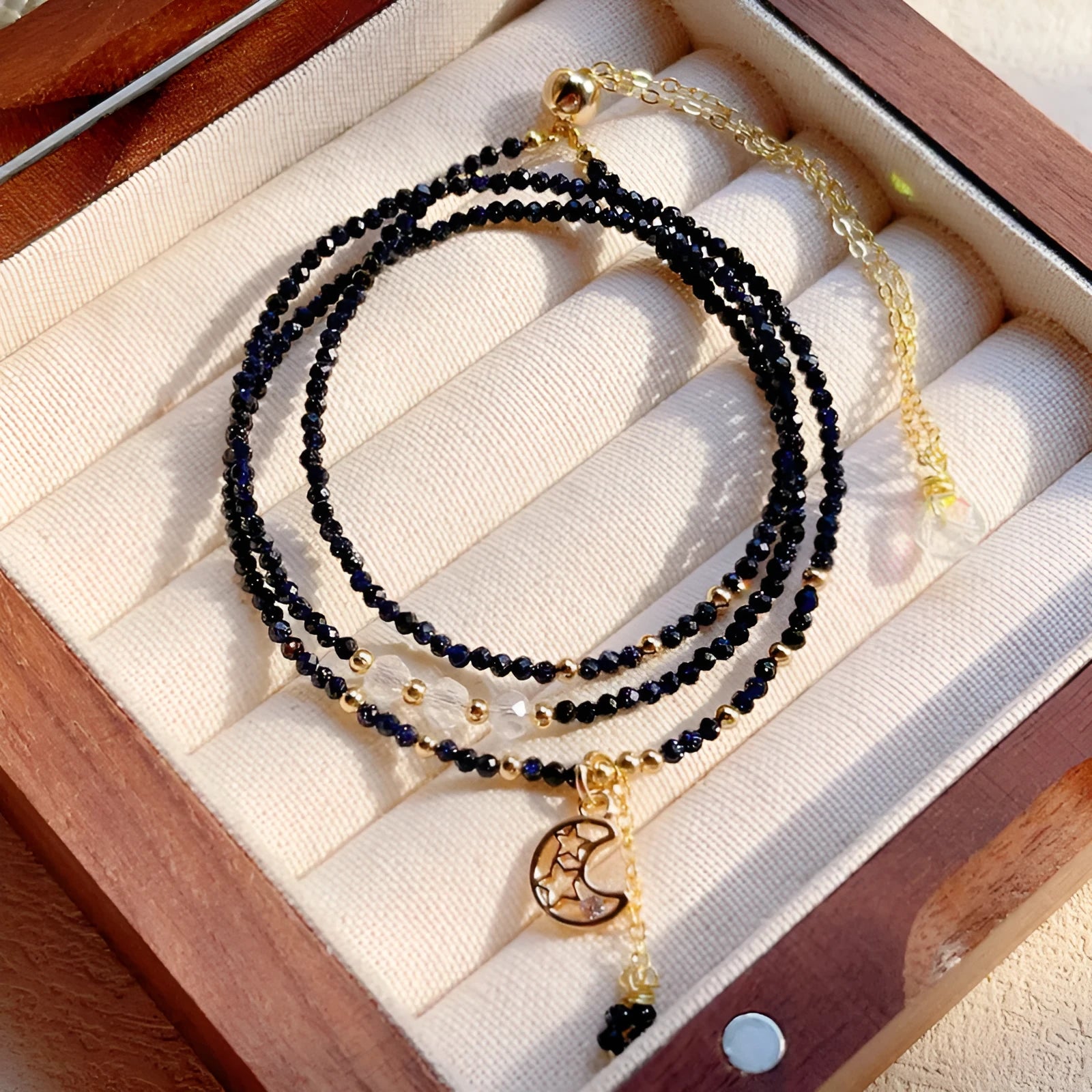 Women's three-ring bracelet with blue sand stone beads in multi-layered gold-tone design