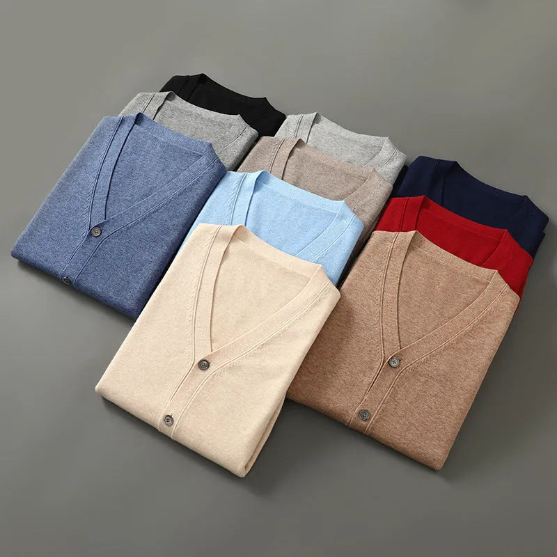 Man wearing a beige Andy velvet V-neck cardigan coat with long sleeves in a loose fit.