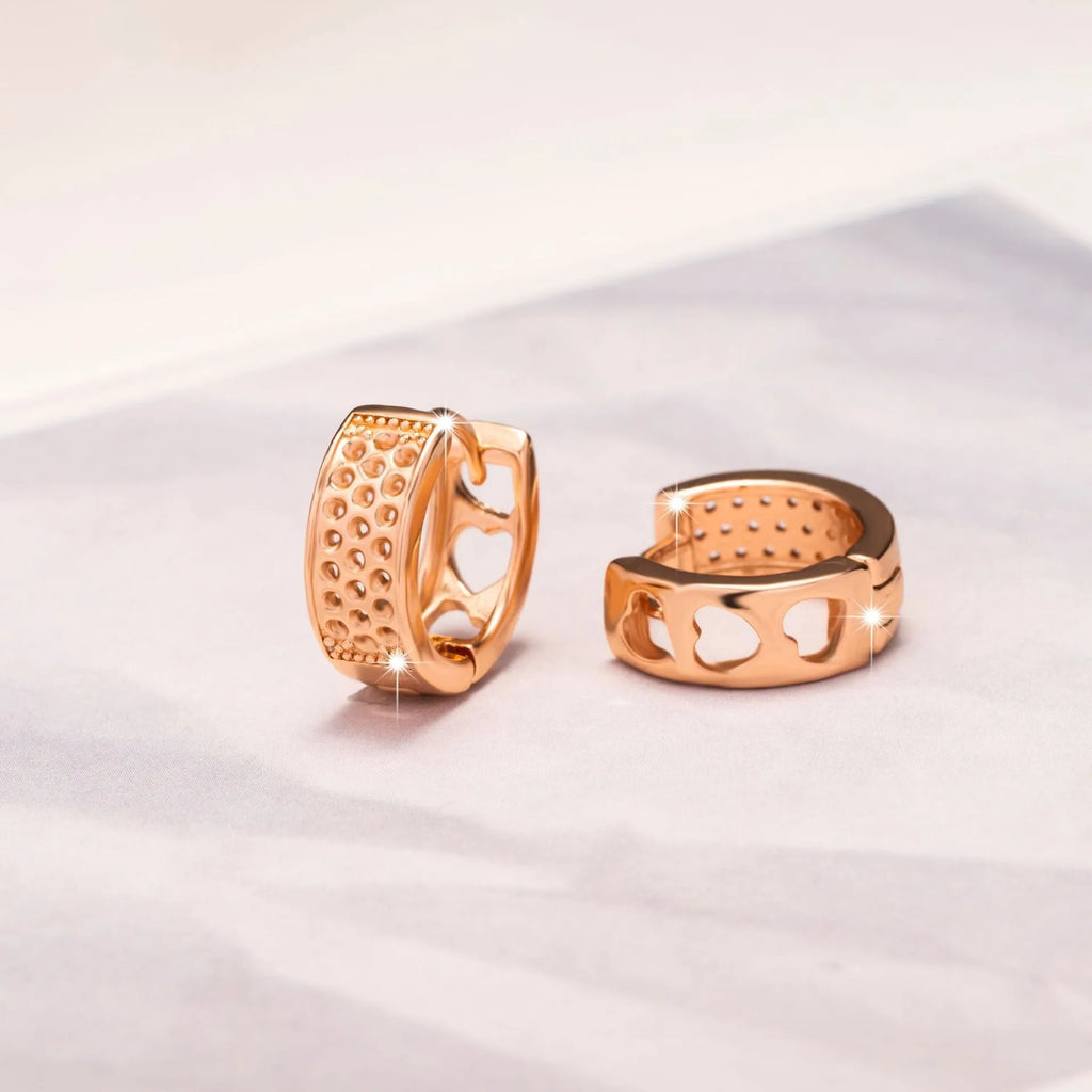 Rose gold electroplated women's earrings with three hollowed heart shapes in circular arrangement