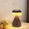 Black USB-charging LED night lamp with three-colour dimming on a wooden bedside table.