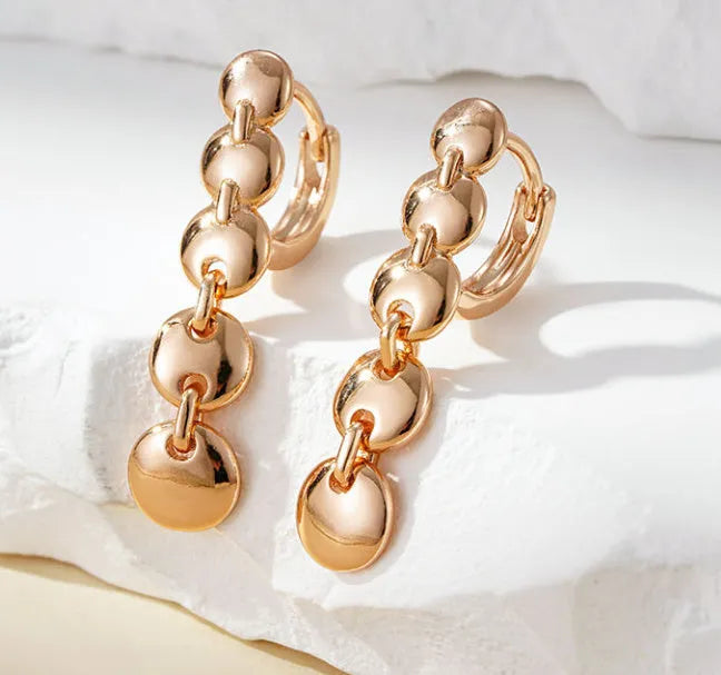 Long gold retro hoop earrings with woven copper texture, shown as a pair.