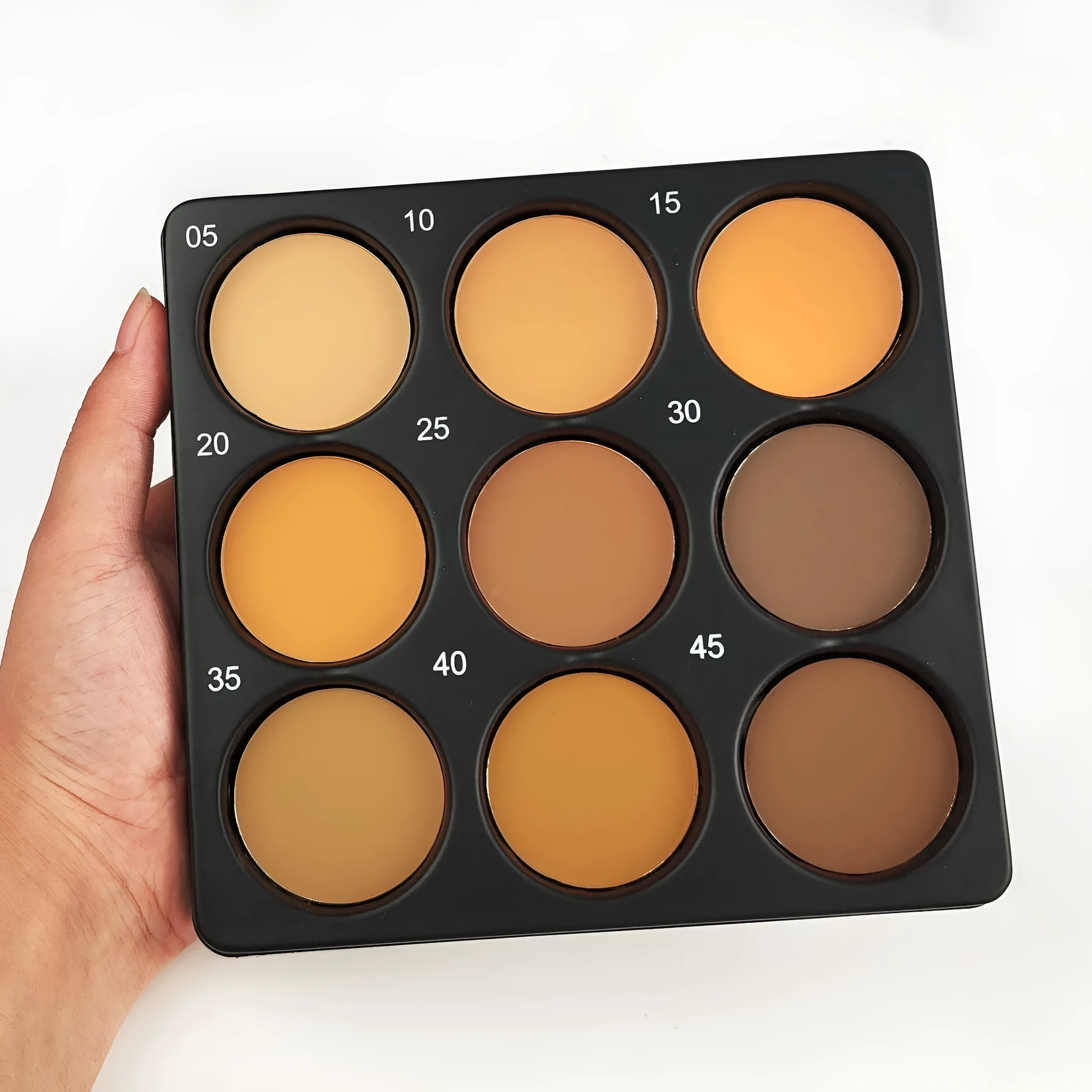Open 9-colour dark matte eyeshadow palette with repair disk, for punk and fashion makeup styles.