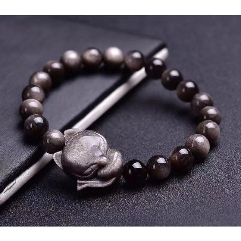 Obsidian fox single ring bracelet showing detailed fox carving on 8mm polished black stone band