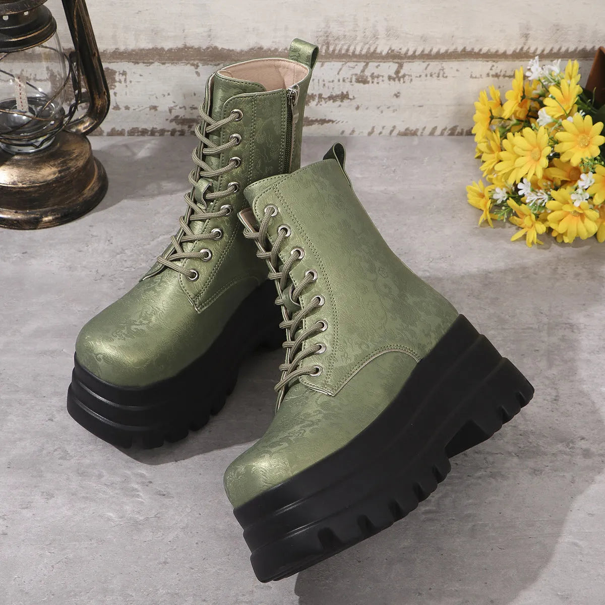 Women's black platform Martin boots with chunky heel and side zipper on a white background.
