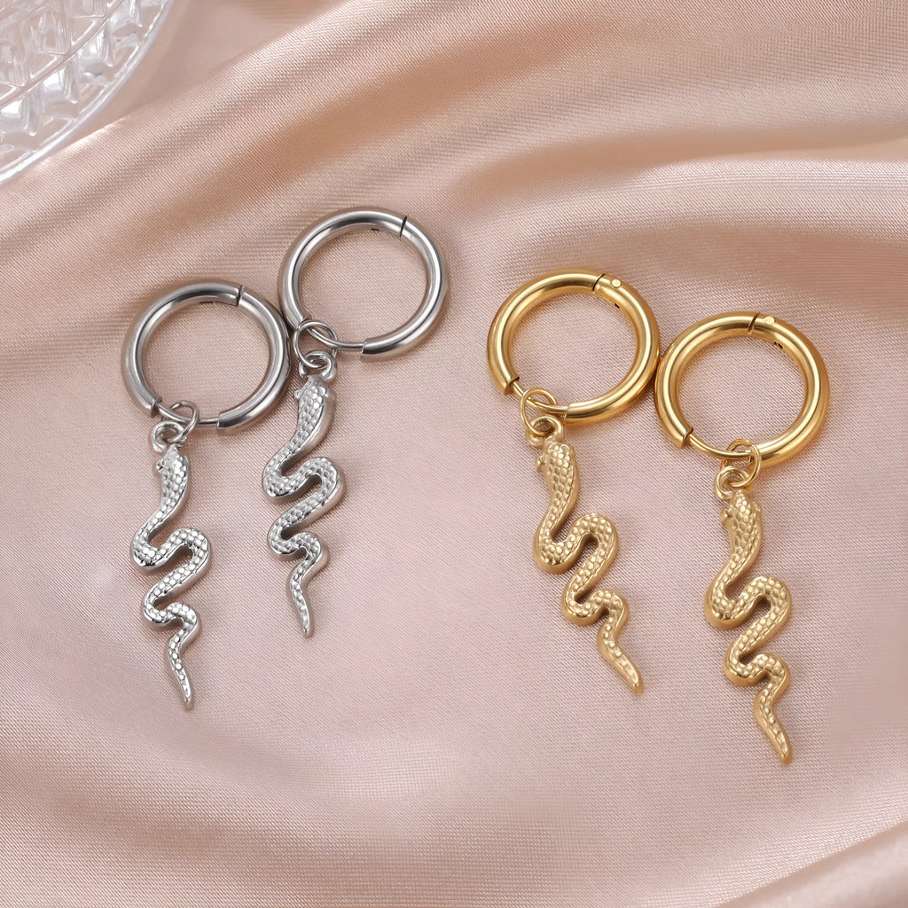 A pair of vintage-style snake-shaped earrings made from gold plated stainless steel with an ear clip fastening.