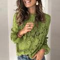 Women's green hollow lace shirt with round neck and long sleeves on a hanger