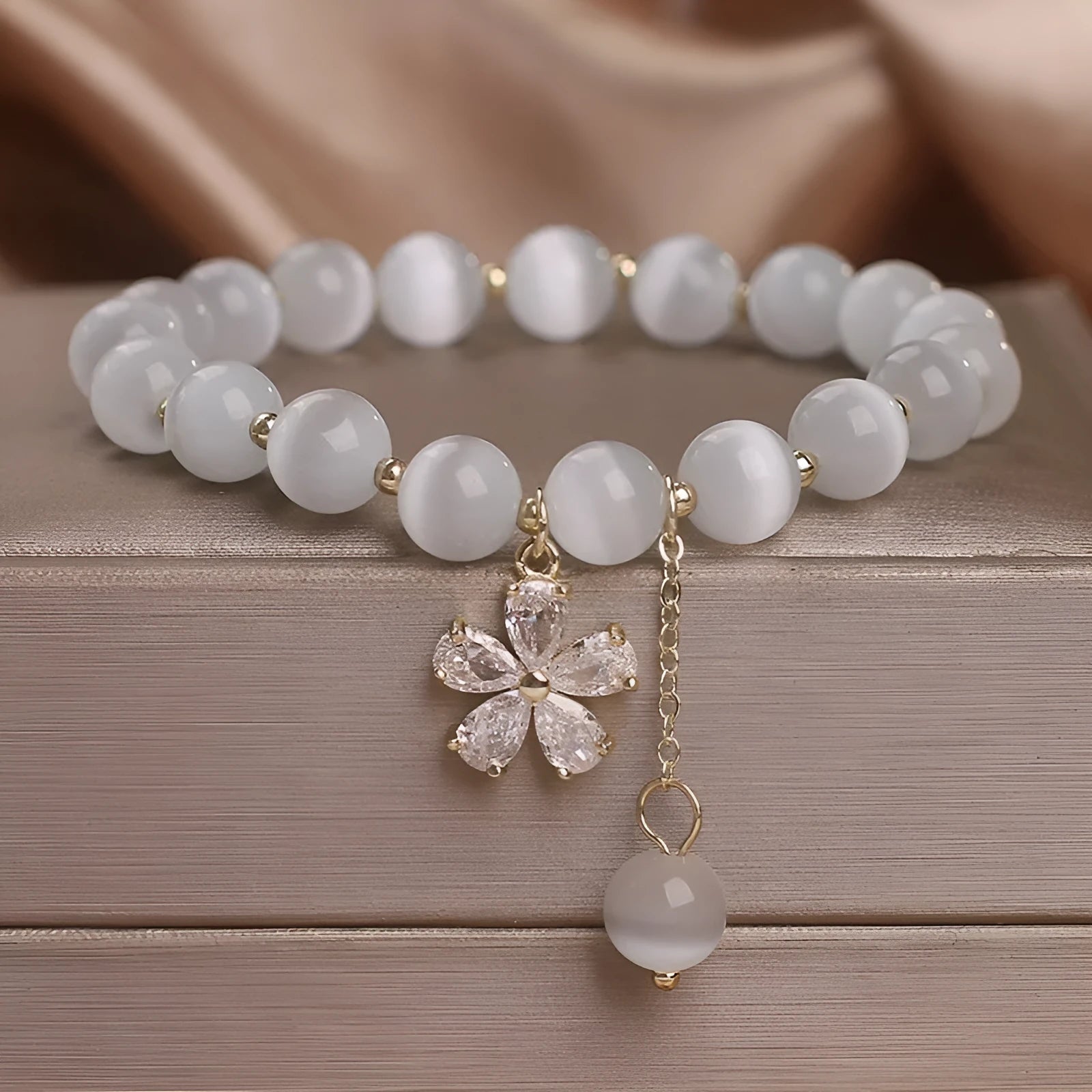 Women's white cat's eye crystal bracelet with flower tassel charm and safety buckle pendant clasp