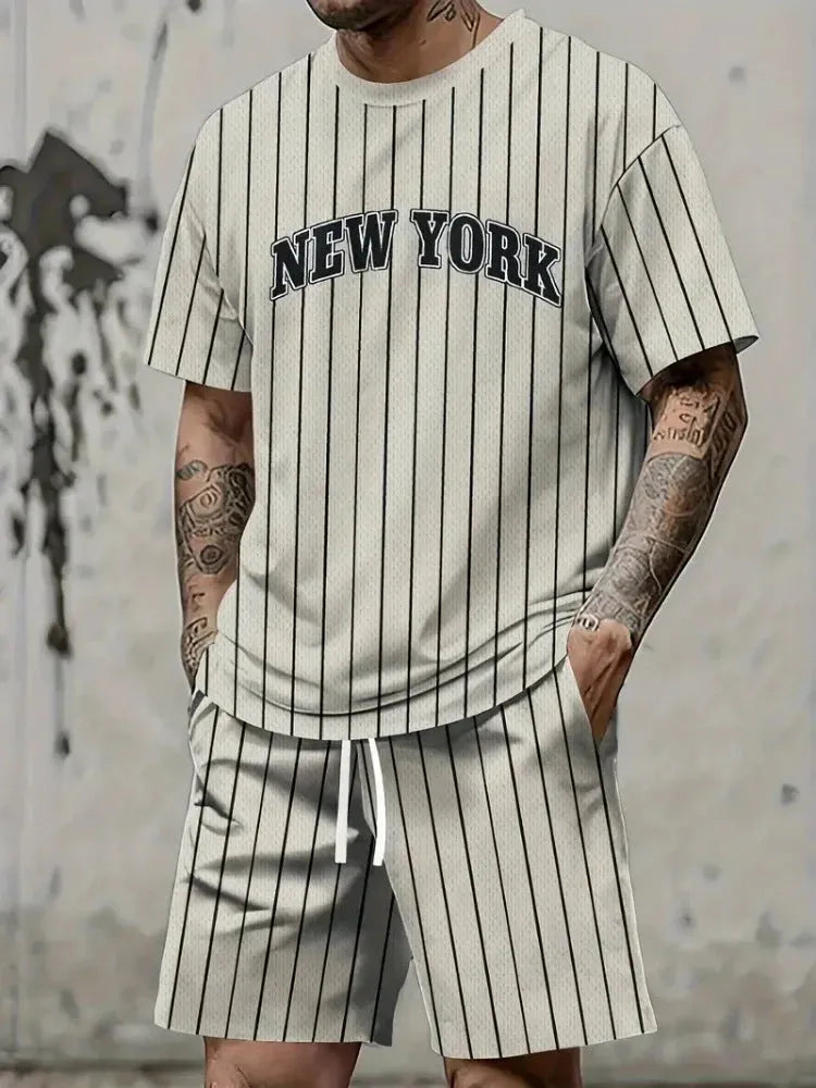 Man wearing a grey 3D printed letter short sleeve top and matching shorts suit set.