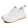 Beige women's low-top leather sports shoes with cross strap and English muffin heel