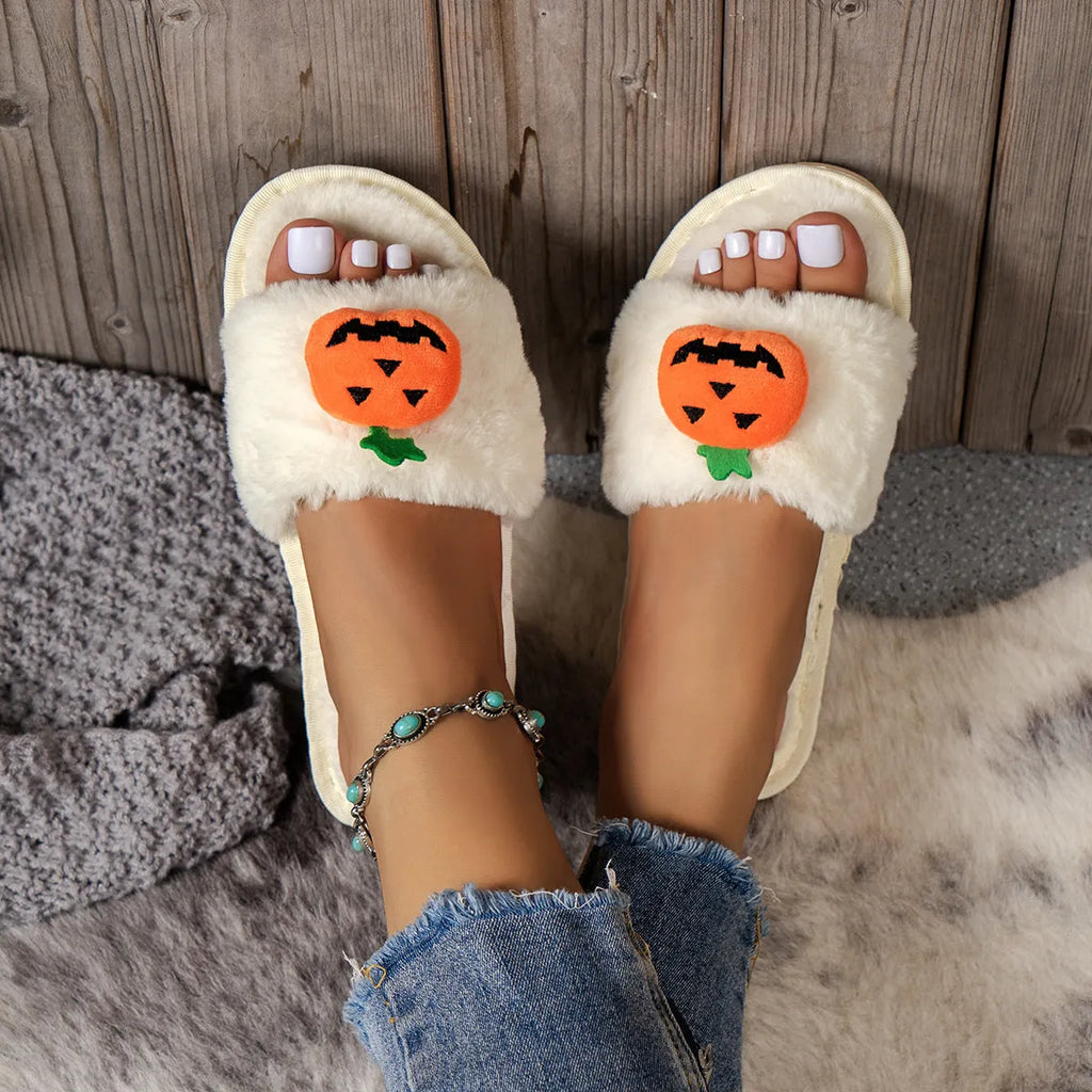 Halloween pumpkin plush slippers with open toe design in yellow colour showing synthetic fur and anti-slip soles