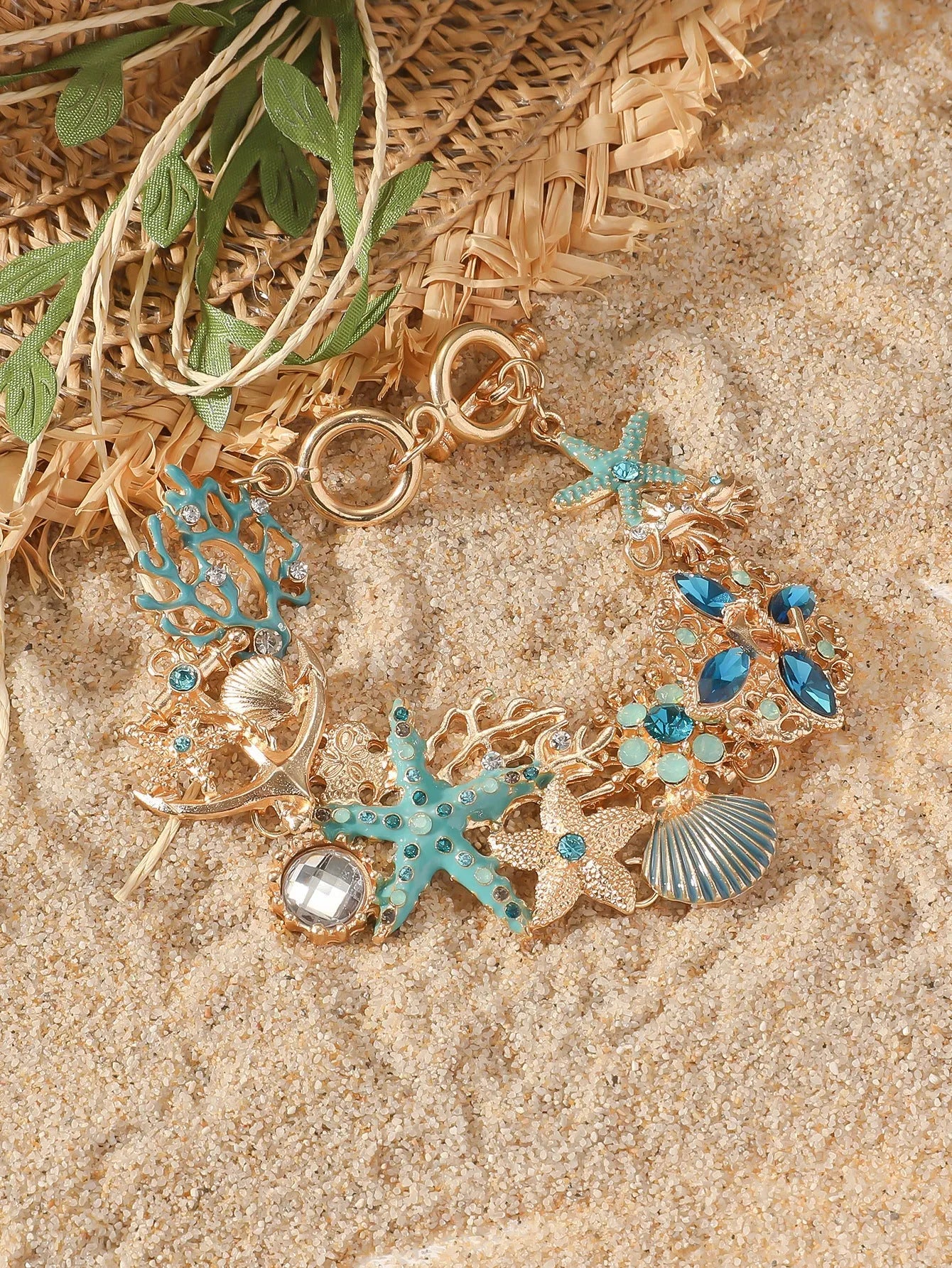 Alloy nautical bracelet with starfish, marine shell and boat anchor charms in turquoise colour