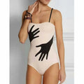 A women's one-piece bikini swimsuit with a gauze skirt, shown in a colour option.
