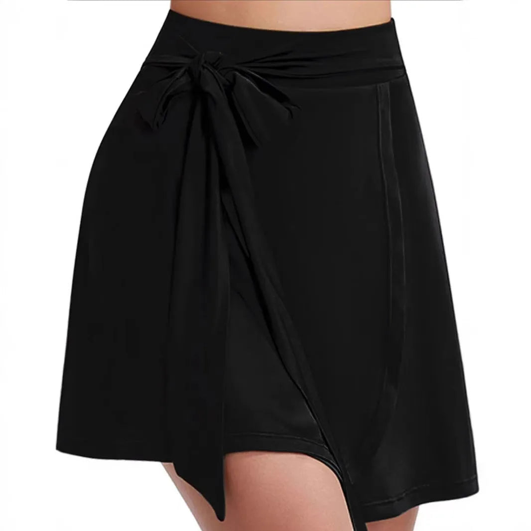 Black thigh-length sports skirt with built-in shorts, showing high waist and culotte style.