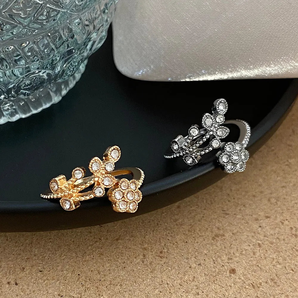 Women's open ring with diamond-cut floral leaf design in gold finish